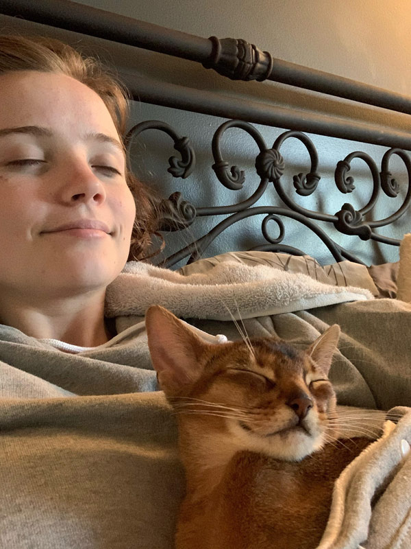girl sleeping with cat