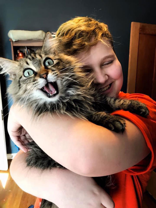 happy cat being hugged